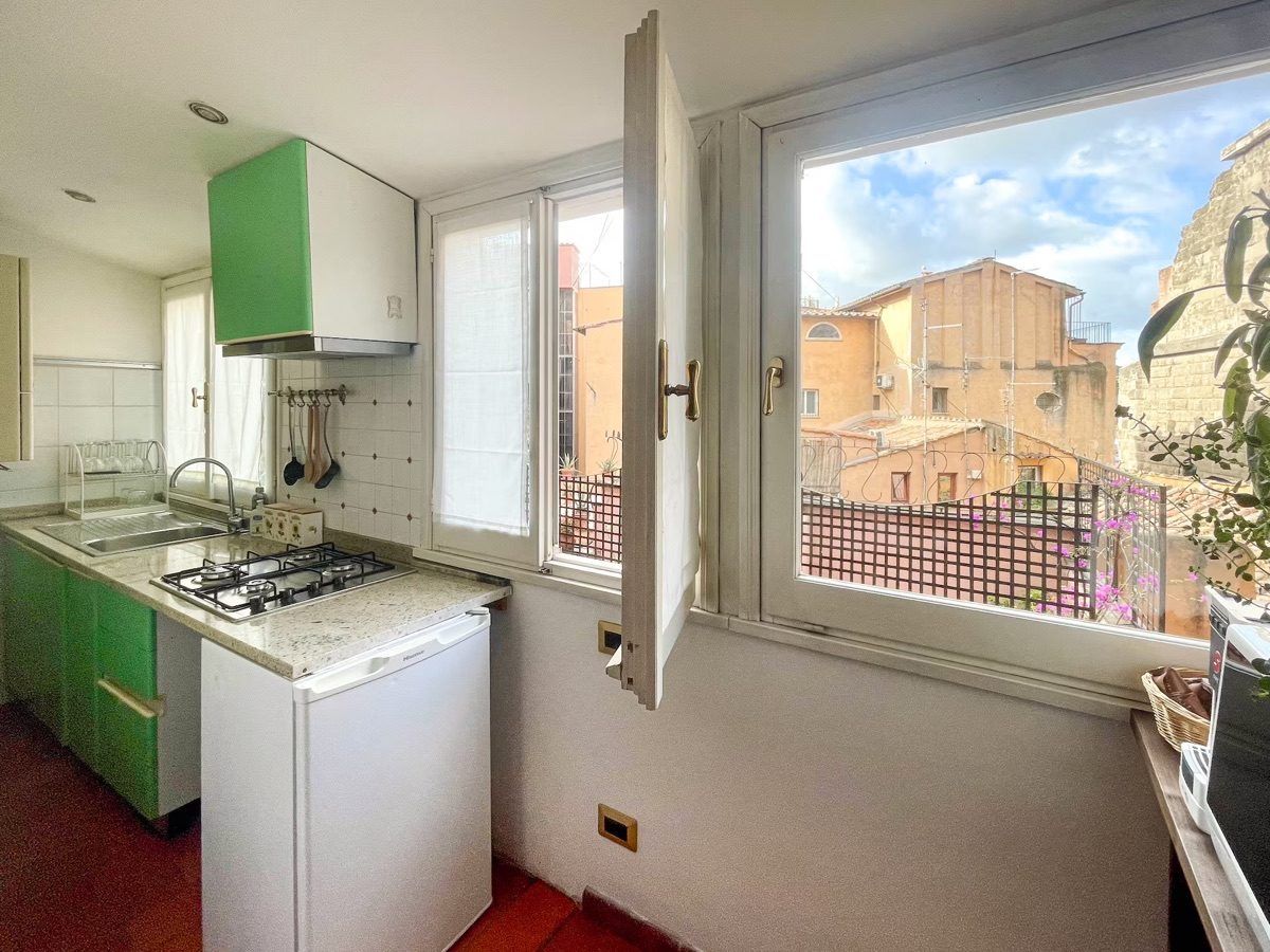 La Casa di G — Kitchen with Rome rooftop view